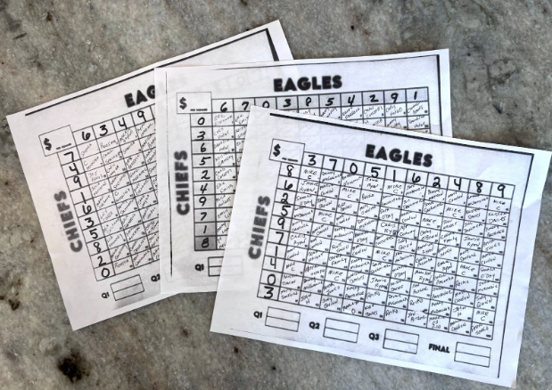 Picture of handwrittten paper Super Bowl grids.