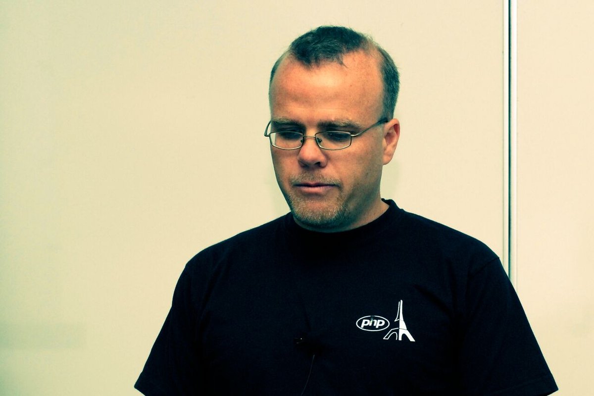 Rasmus Lerdorf, the creator of PHP, wearing a black PHP T-shirt at the 2007 OSCMS Summit.